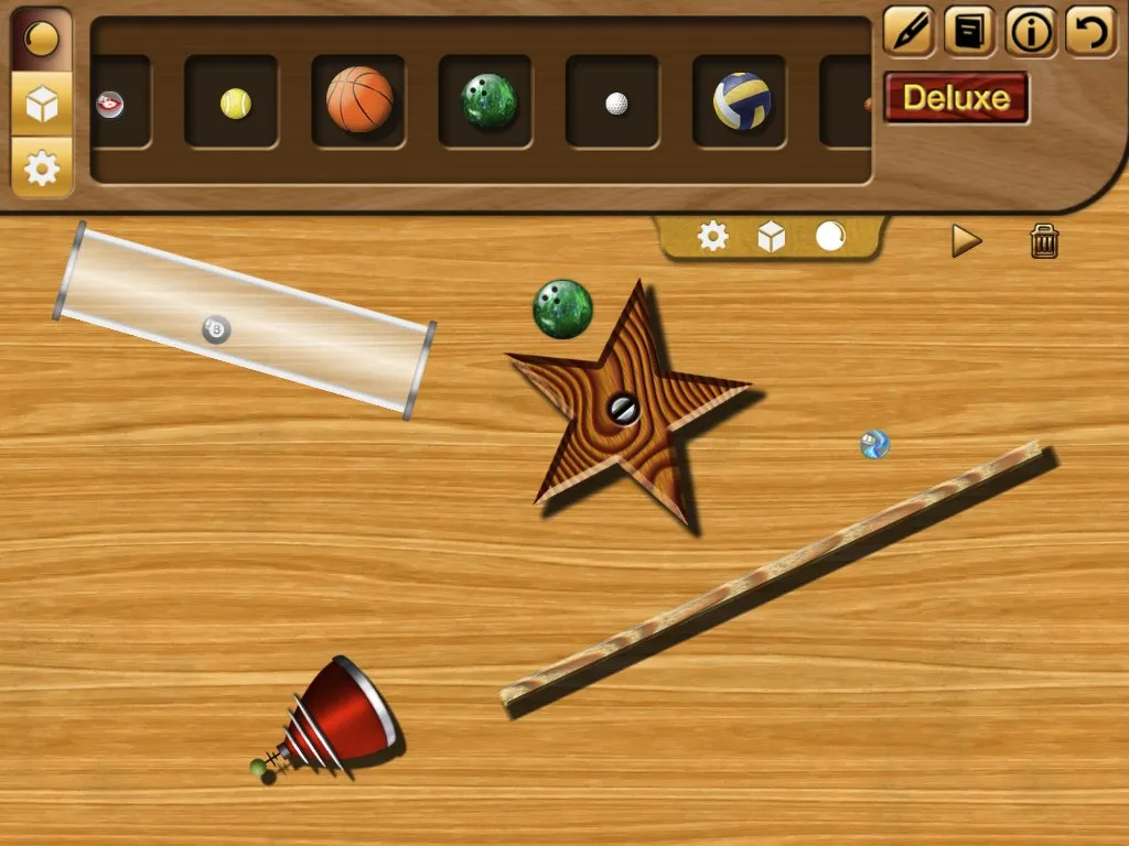 The BallFallDown build tray open, with a plank, a tube, a spinner and a funnel placed on the wooden board.